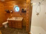Main floor master bathroom with a large shower stall and claw foot tub 